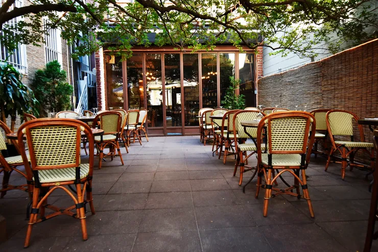A restaurant with many chairs and tables outside