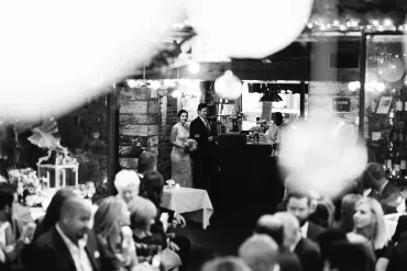A black and white photo of people in a restaurant.