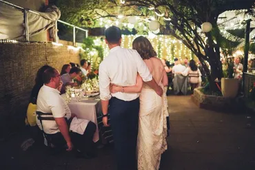 A couple is standing in front of some tables