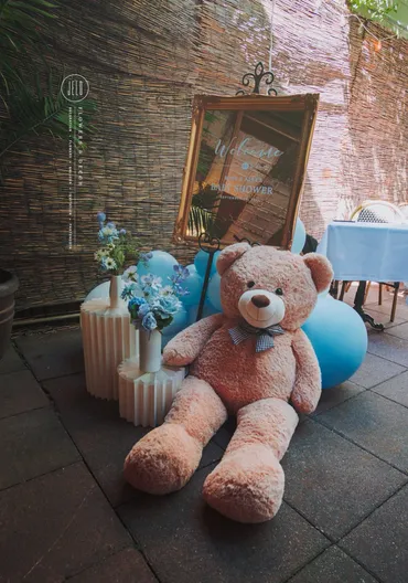 A large teddy bear sitting on top of a floor.