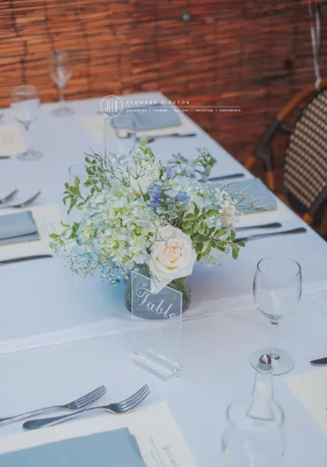 A table with white and blue flowers on it