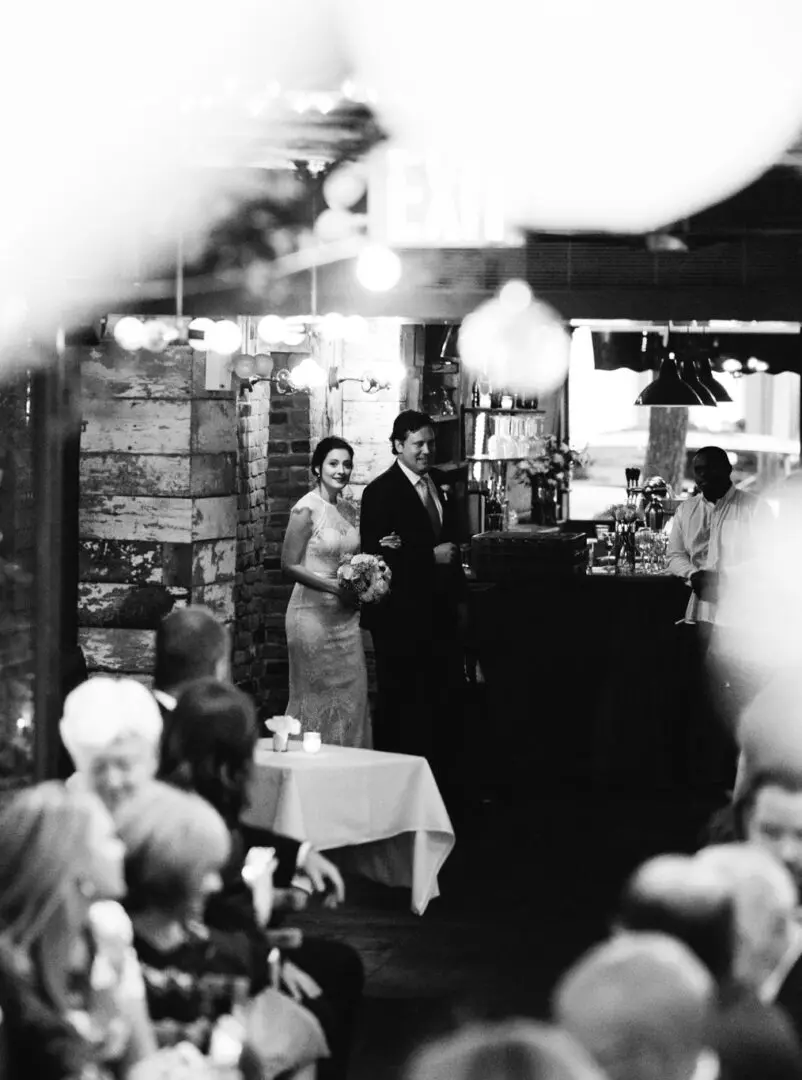 A couple standing in front of a bar.