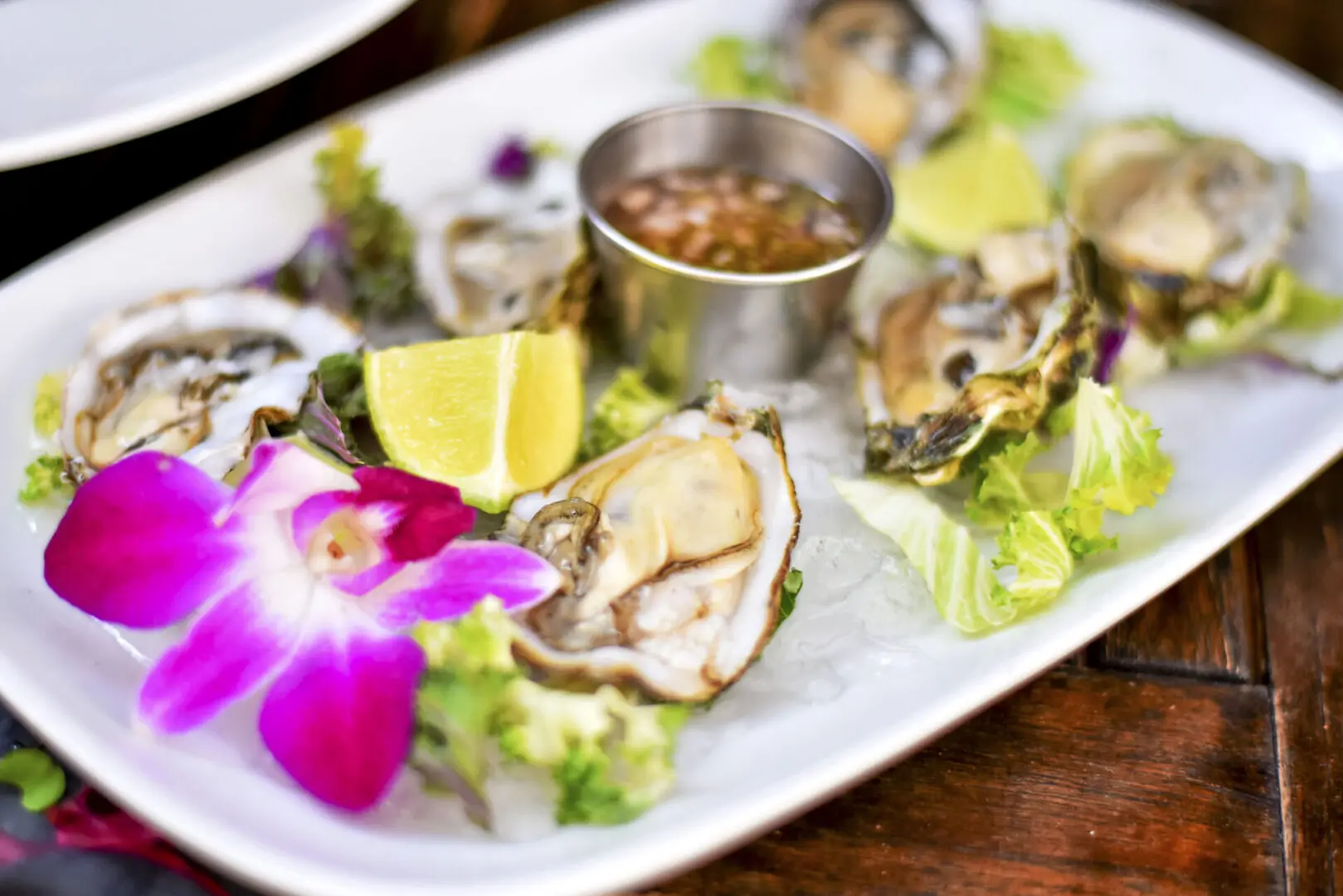 A plate of food with oysters and lemon.