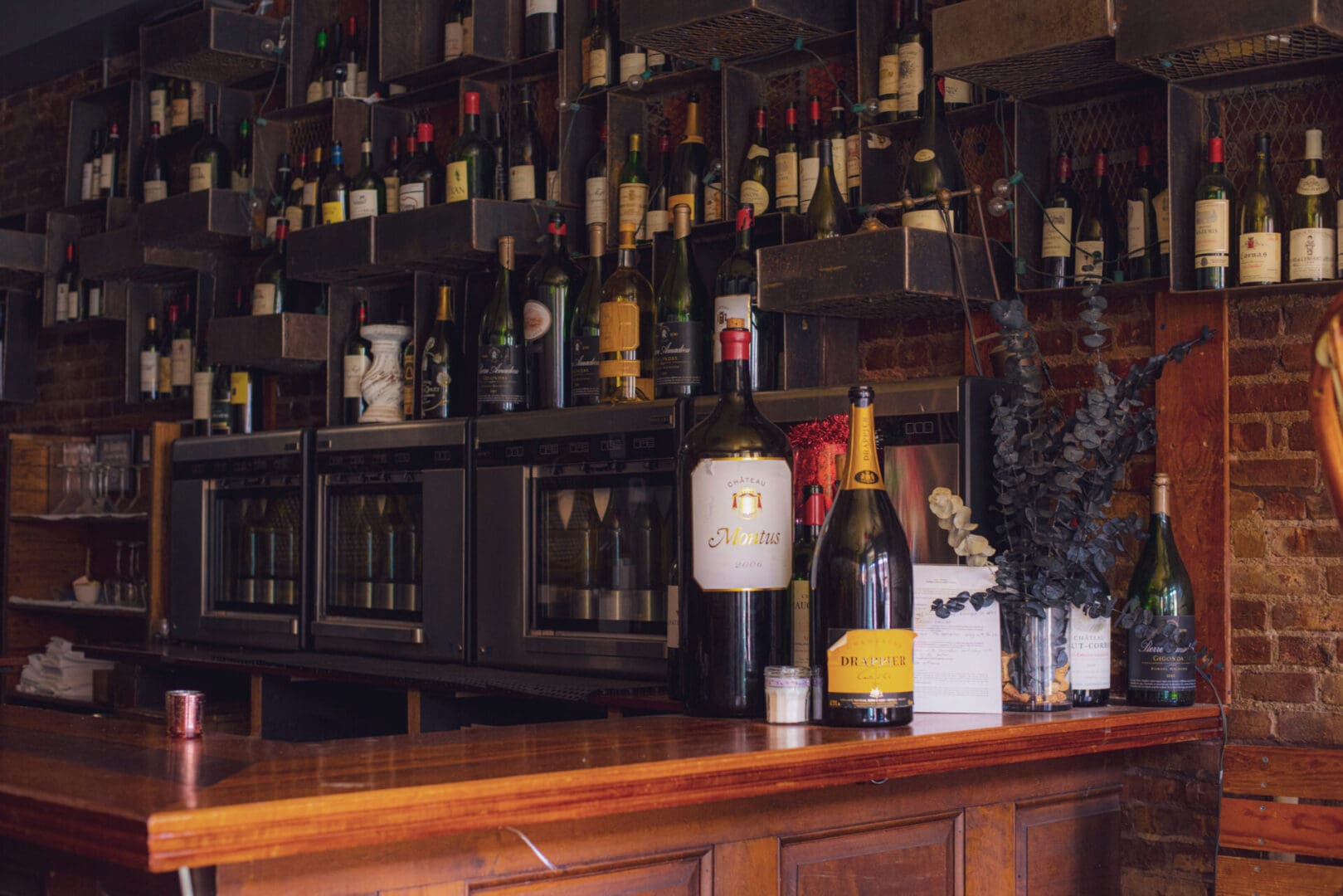 A bar with many bottles of wine on the counter