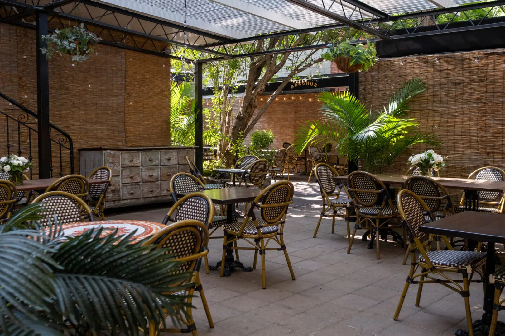 Outdoor patio with bistro tables and chairs.